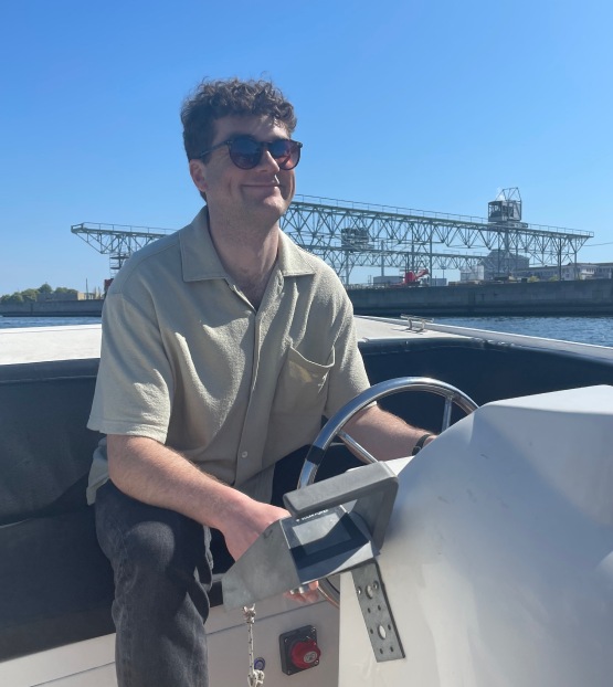 Me steering a boat during a work trip to Copenhagen